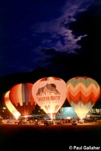 Hot air balloons taking off at dawn