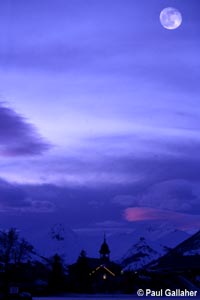 Moonrise over town in winter
