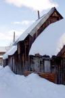 Snow covers a historic shed in one of Crested Butte’s back alleys