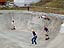 Local skaters from The Air Up There Skate Shop, (train order) Melissa Walker, Mark 5, Brian Vicente and Ryan Gertken, all form a train at Crank's Plank Skating Park.