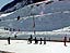 The kindergartners from Stepping Stones enjoy a sunny day on the ice rink, as well as some Nordic skiers behind them.