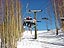 Skiers ride Painter Boy chairlift on a sunny morning.