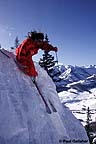 Skier coming over cornice