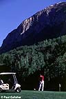 Golfer with mountain in background