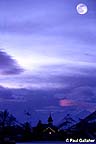 Moonrise over town in winter