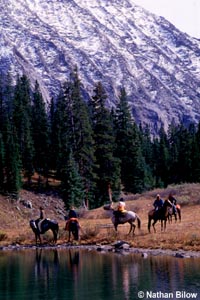 Mountain lake with horseback riders