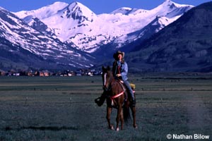 Horseback rider with town in background